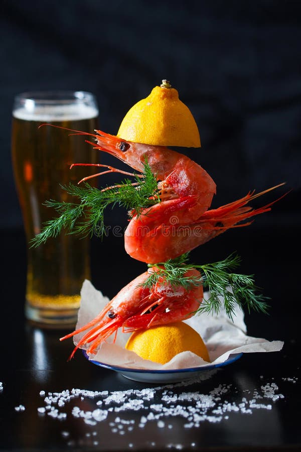 Delicious Large Shrimp with Salt and Beer on a Dark Table Stock Photo