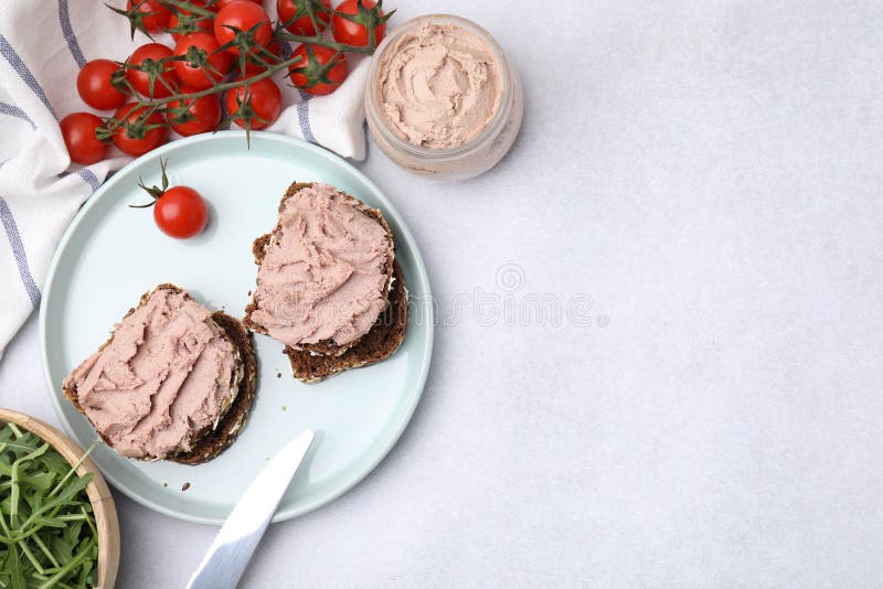Delicious Liverwurst Sandwiches, Tomatoes and Arugula on White Table