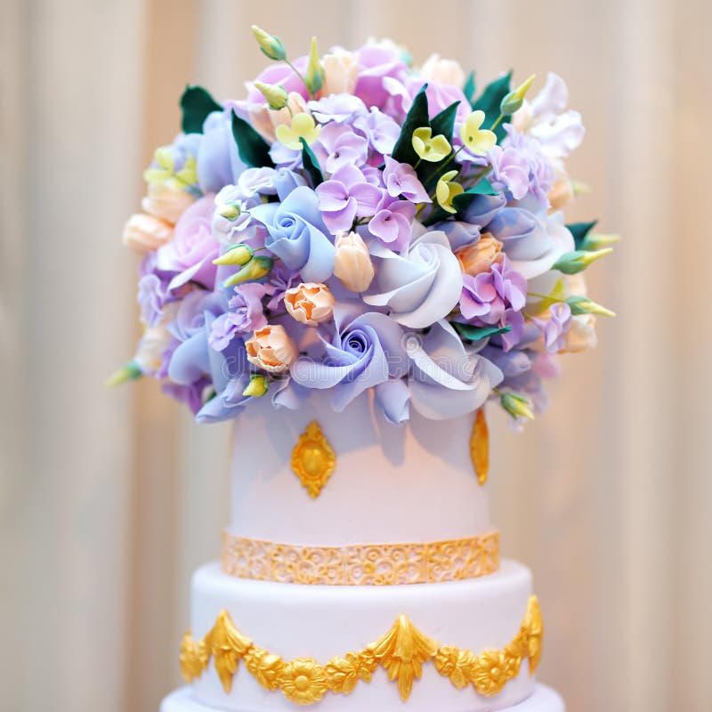 Delicious luxury white wedding or birthday cake. Decorated with cream colorful flowers stock image Delicious luxury white wedding or birthday cake. Decorated with cream colorful flowers stock image