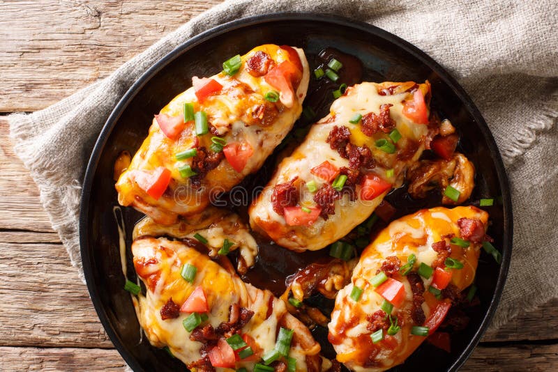 Delicious Monterey chicken breast baked with cheese, bacon, tomatoes and barbecue sauce close-up. Horizontal top view royalty free stock images Delicious Monterey chicken breast baked with cheese, bacon, tomatoes and barbecue sauce close-up. Horizontal top view royalty free stock images