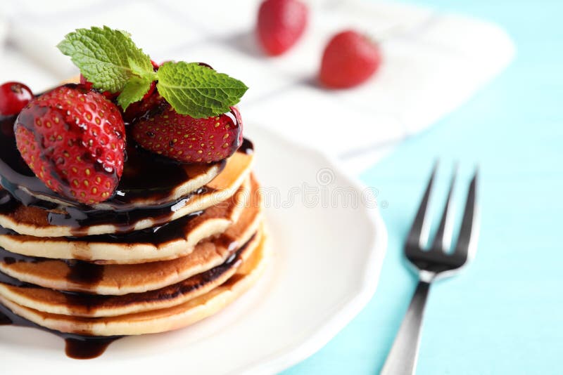 Delicious Pancakes with Fresh Strawberries and Chocolate Syrup on Light ...