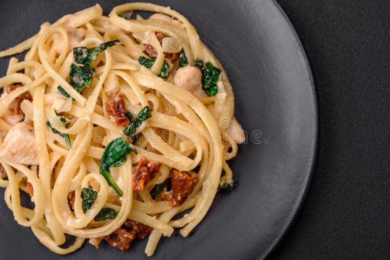 Delicious Pasta with Spinach, Sun Dried Tomatoes, Cheese, Onions Stock