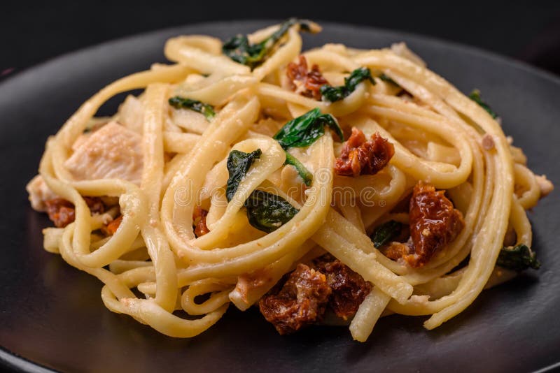 Delicious Pasta with Spinach, Sun Dried Tomatoes, Cheese, Onions Stock