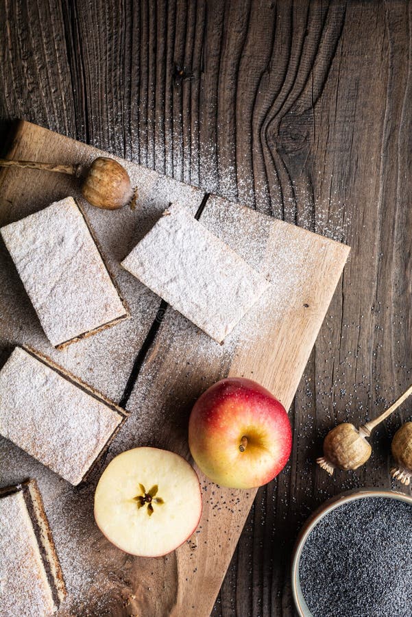 Delicious pie made from leavened dough with poppy seed and apple filling, sprinkled with powdered sugar