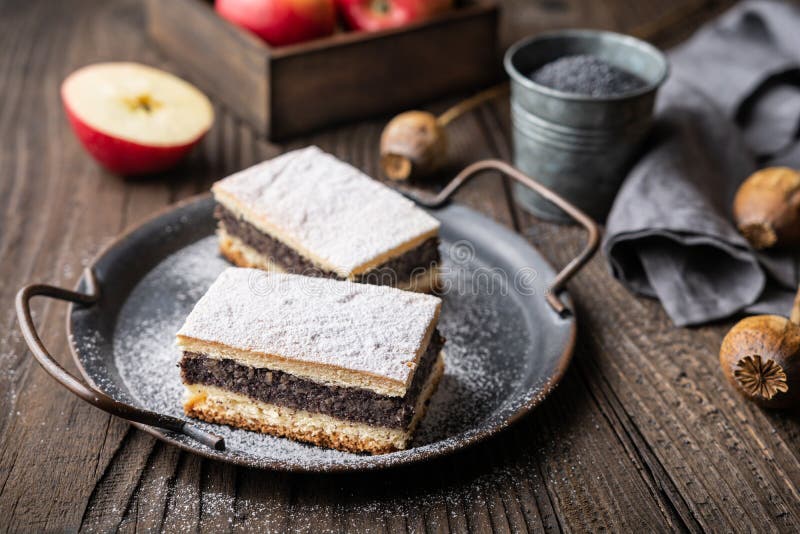 Delicious pie made from leavened dough with poppy seed and apple filling, sprinkled with powdered sugar