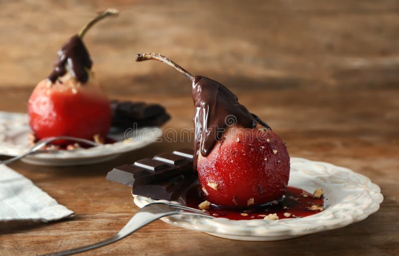 Delicious Poached Pear in Red Wine with Chocolate Sauce on Plate Stock