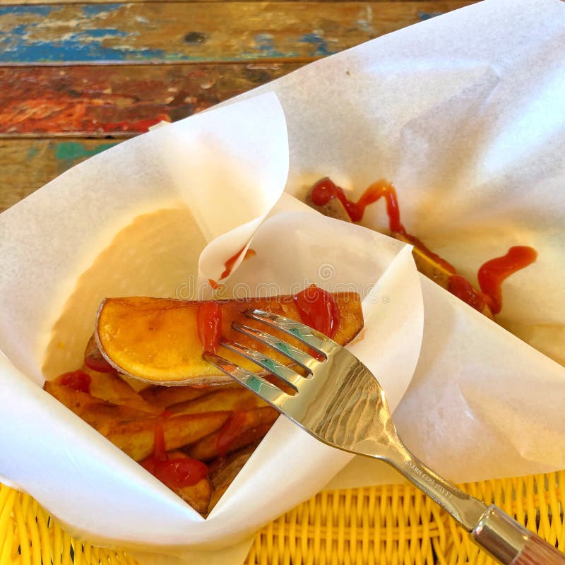 The delicious potato chips, with ketchup on it stock photos The delicious potato chips, with ketchup on it stock photos
