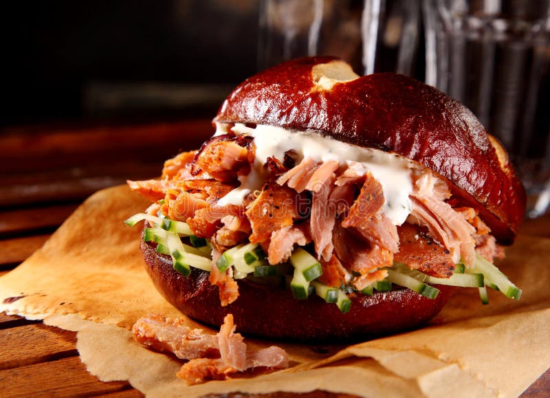 Delicious pulled pork burger on rustic wooden plate royalty free stock image Delicious pulled pork burger on rustic wooden plate royalty free stock image