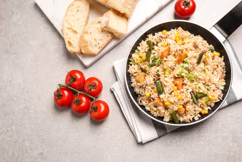 Delicious Rice Pilaf with Chicken and Vegetables on Light Grey Table