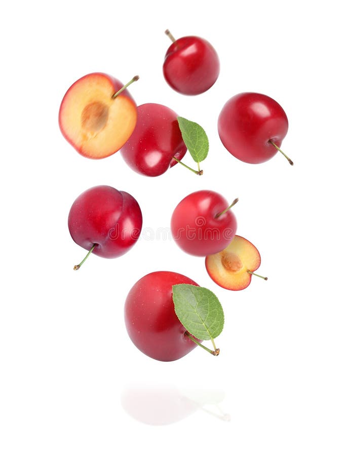 Delicious Ripe Cherry Plums with Leaves Falling Isolated on White Stock