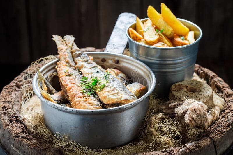 Delicious Roasted Herring Fish with Salt on Old Barrel Stock Image