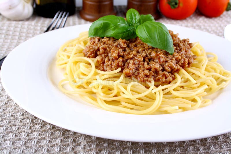 Delicious Spaghetti Bolognese with Basil on White Plate Stock Photo