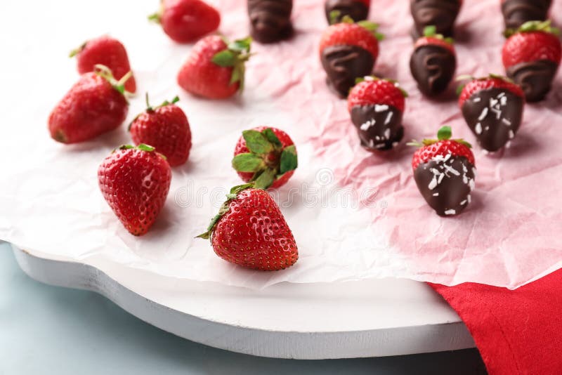 Delicious Strawberries Covered with Chocolate on Parchment Stock Image