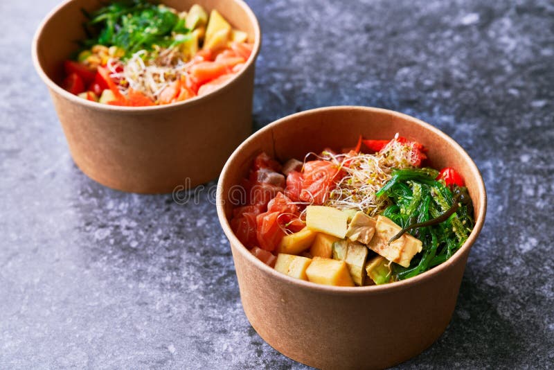 Delicious Take Away Poke Bowls on a Concrete Surface Stock Photo