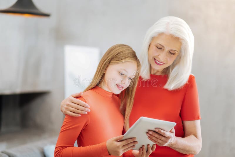 Delighted cute girl using a tablet