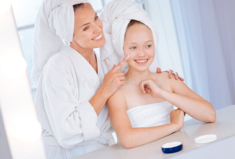 Delighted girl being glad of beauty procedure