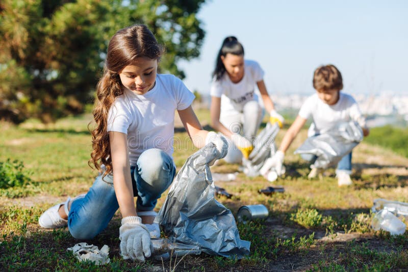 Delighted girl working in volunteer group