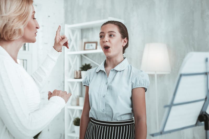 Delighted happy girl raising the tone of her voice stock image Delighted happy girl raising the tone of her voice stock image