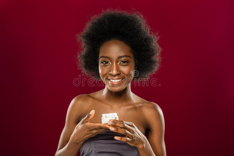 Delighted positive woman holding a bottle with cream stock photos Delighted positive woman holding a bottle with cream stock photos