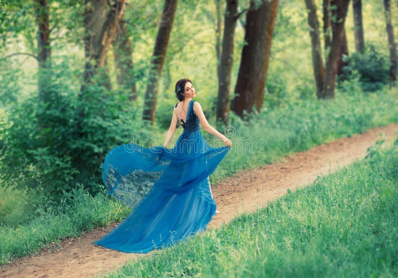 Delightful gentle dancing girl, a young beautiful princess walks along secret forest paths. lady lifts the hem of an