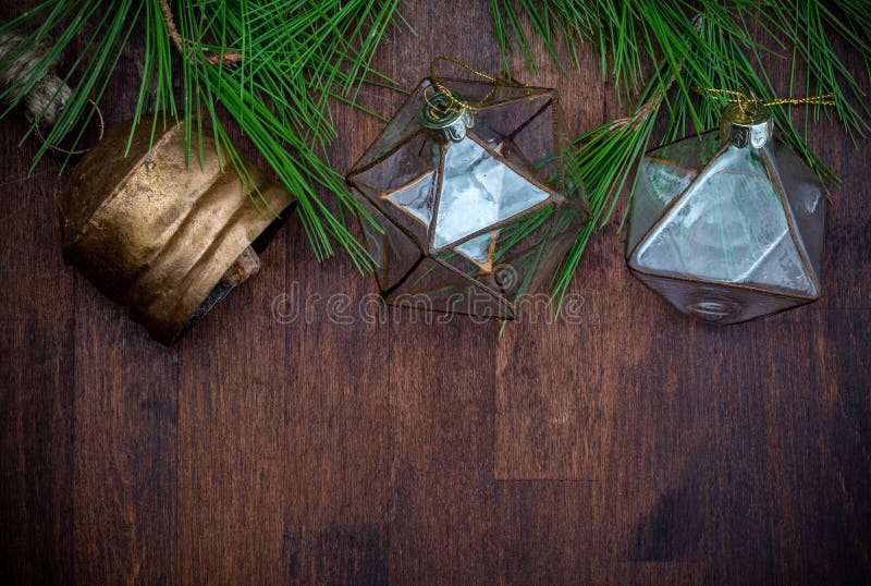 Delicate glass Christmas ornaments and natural branches of pine spruce on wooden background. Ready for Christmas greeting. Delicate glass Christmas ornaments and natural branches of pine spruce on wooden background. Ready for Christmas greeting