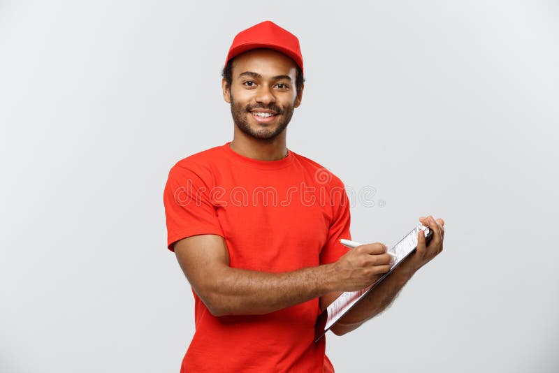 Delivery Concept - Portrait of Handsome African American delivery man or courier writing on a order document. Isolated on Grey studio Background. Copy Space