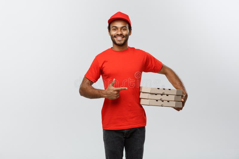 Delivery Concept - Portrait of Happy African American delivery man pointing hand to present a box package. Isolated on stock images Delivery Concept - Portrait of Happy African American delivery man pointing hand to present a box package. Isolated on stock images