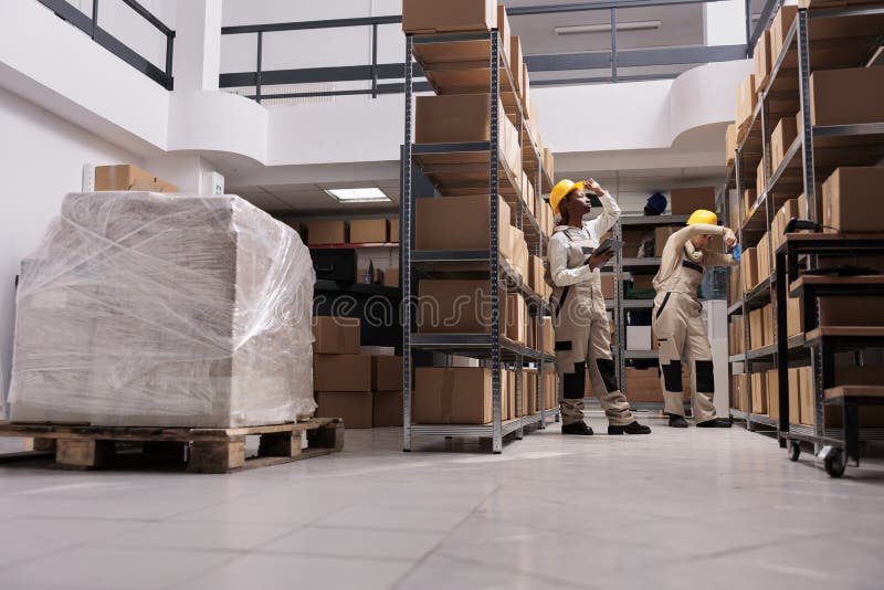 Delivery Department Worker Using Tablet, Finding Parcel in Warehouse