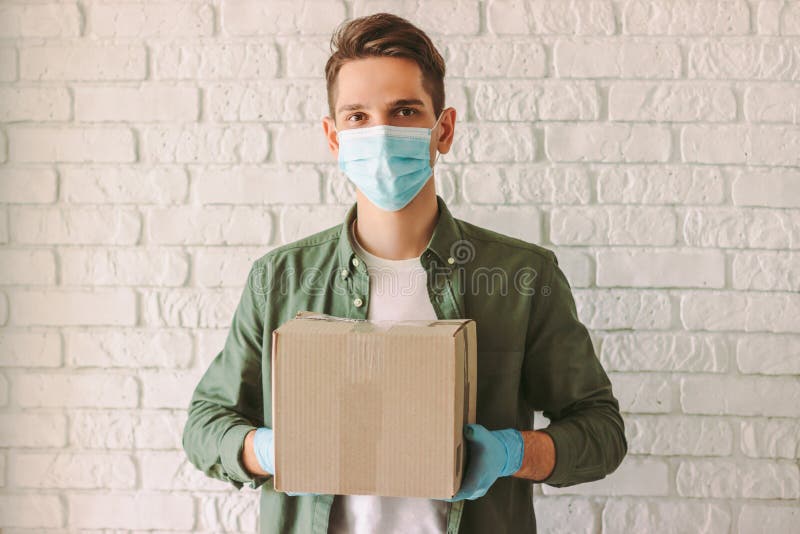 https://thumbs.dreamstime.com/b/delivery-guy-medical-face-mask-gloves-carrying-cardboard-box-hands-hipster-man-courier-rubber-hold-happy-service-employee-185373170.jpg