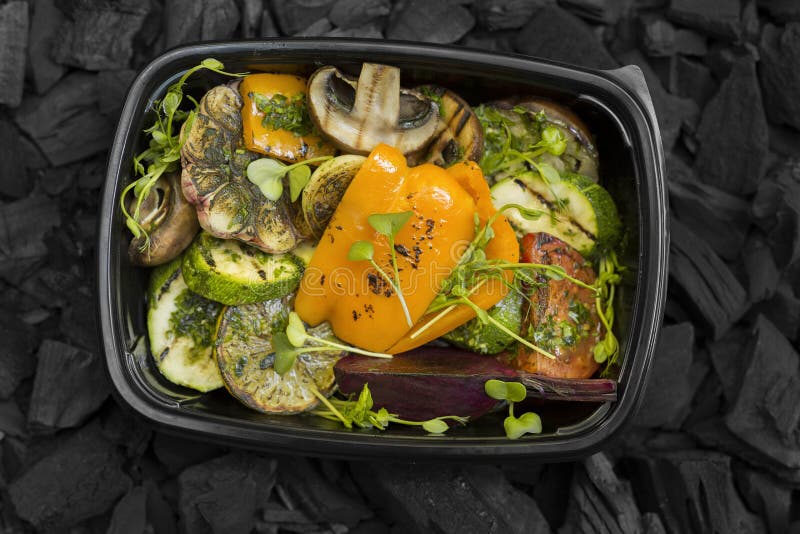 Grilled vegetables in take away black box on coals background royalty free stock photos Grilled vegetables in take away black box on coals background royalty free stock photos