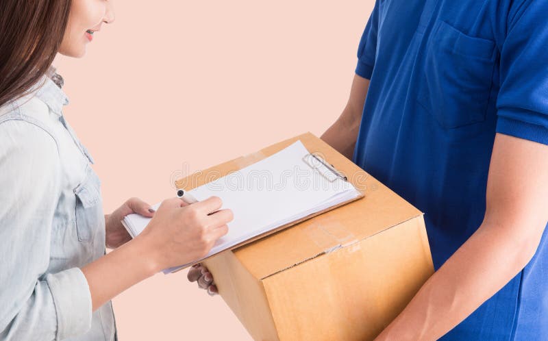 Delivery man giving a cardboard box to young woman stock image Delivery man giving a cardboard box to young woman stock image