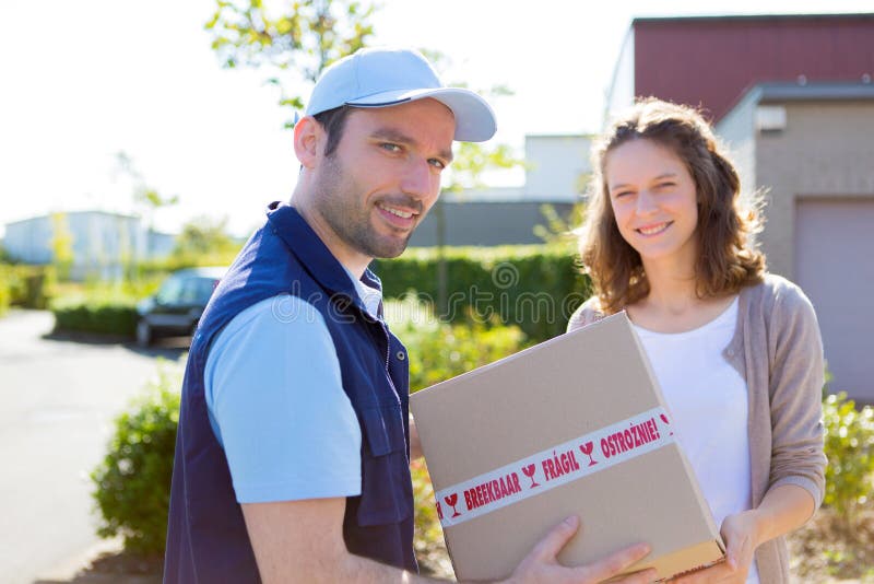 Delivery Man Handing Over Parcel To Customer Stock Photos - Free ...