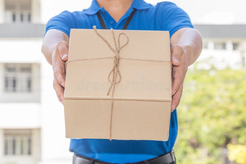 Delivery Man Holding a Parcel Box. Delivery Service Concept Stock Photo