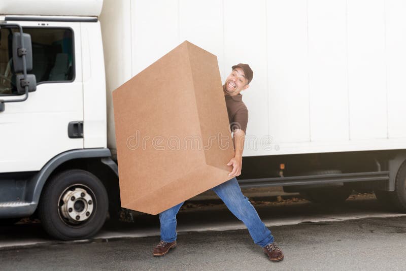 Delivery Man Holding Heavy Box stock images