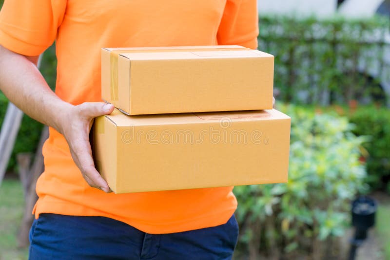 Delivery Man in Orange Handing Packages To a Woman Stock Image Image