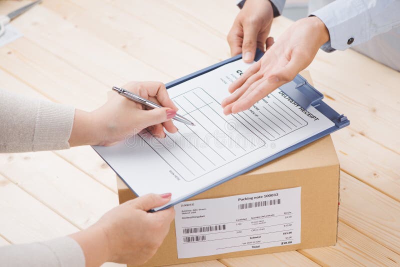 Delivery man presenting receiving form in post office stock photography Delivery man presenting receiving form in post office stock photography