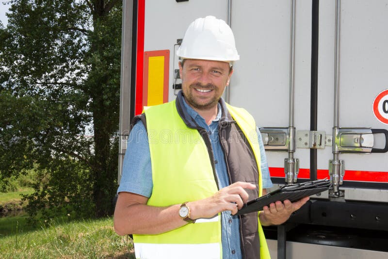 Delivery man specialist using a tablet computer at construction site royalty free stock photo