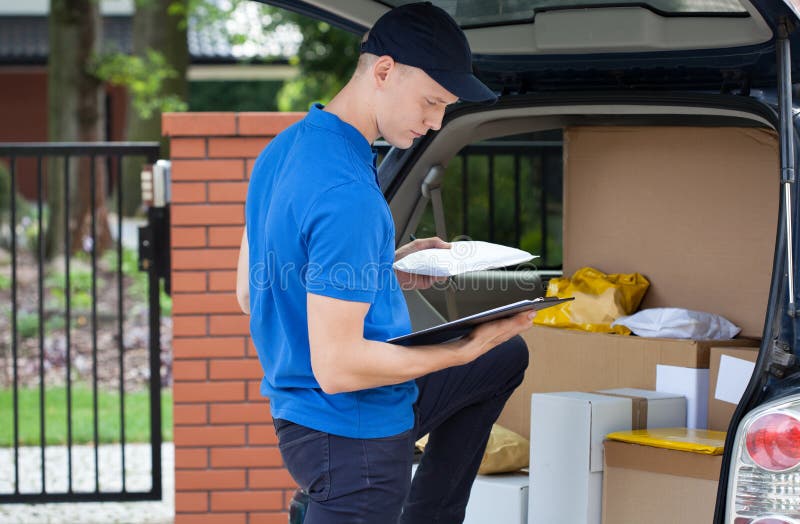 Delivery Man with a Parcel Box on the Street. Stock Photo Image of domestic, houses 112462816