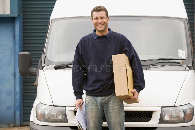 Delivery person standing with parcel royalty free stock images