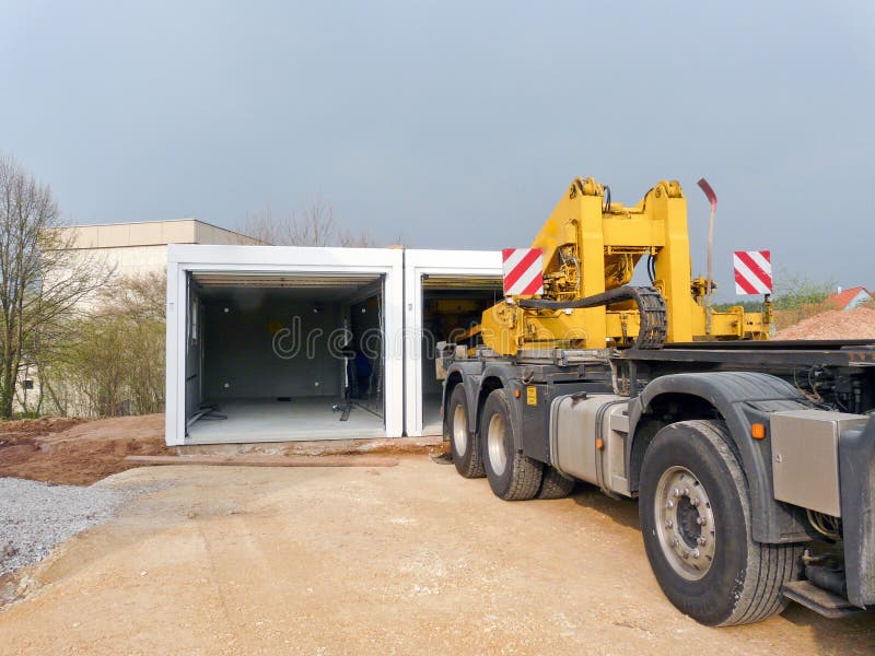 Delivery of a prefabricated garage on construction side royalty free stock images