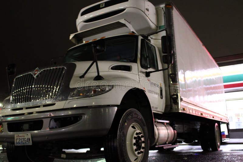 Delivery Truck at a daily Convenience Store Editorial Stock Photo