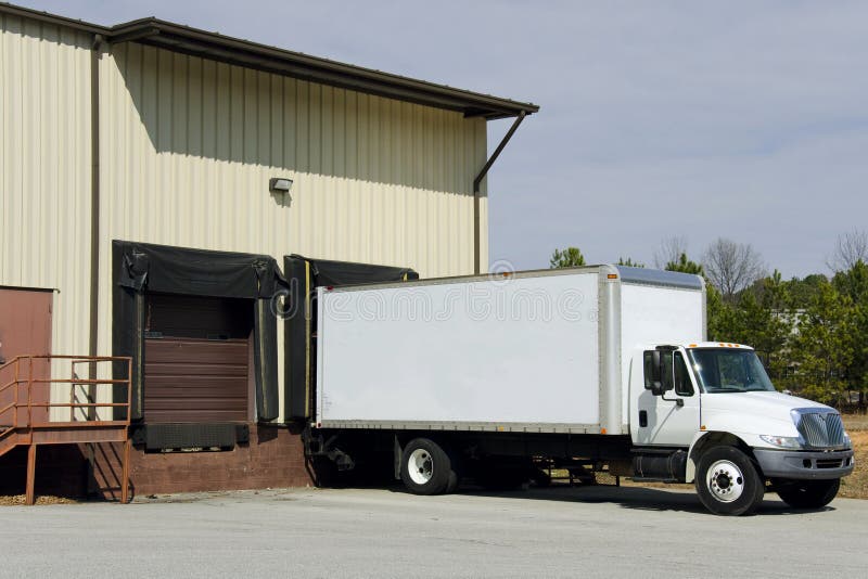 Delivery truck at loading dock stock images