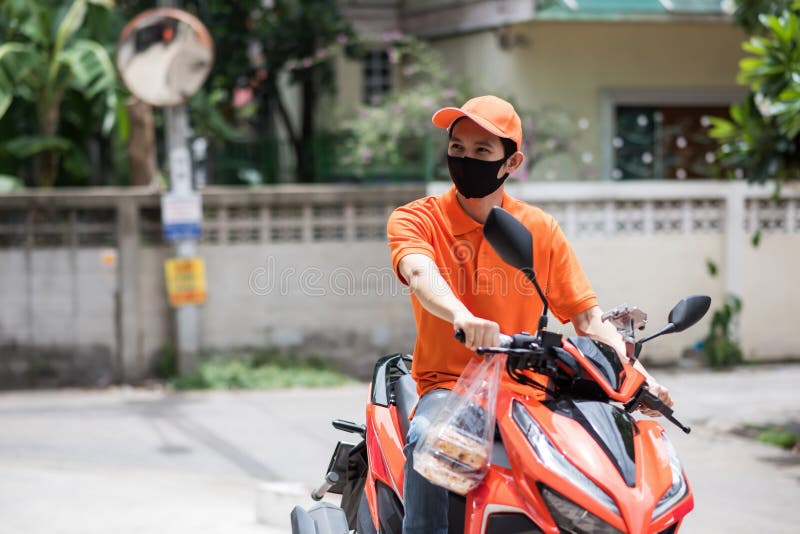 deliveryman with face mask on bike wait for customer