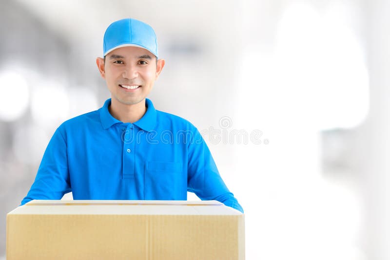 Deliveryman που φέρνει ένα κιβώτιο δεμάτων χαρτονιού στοκ φωτογραφία με δικαίωμα ελεύθερης χρήσης Deliveryman που φέρνει ένα κιβώτιο δεμάτων χαρτονιού στοκ φωτογραφία με δικαίωμα ελεύθερης χρήσης