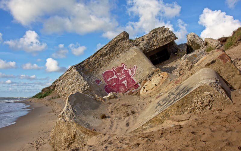 Demolished sovjet bunkers with graffiti on the beach of the Baltic sea, part of a fort in the old Soviet base Karosta in Liepaja, Latvia. Demolished sovjet bunkers with graffiti on the beach of the Baltic sea, part of a fort in the old Soviet base Karosta in Liepaja, Latvia