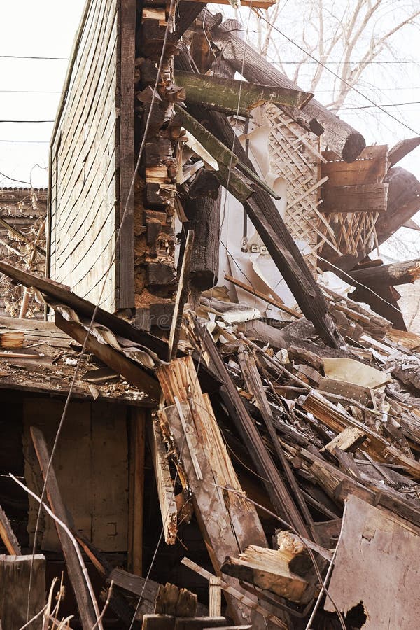 Demolition house using excavator in city. Rebuilding process. Remove equipment royalty free stock images