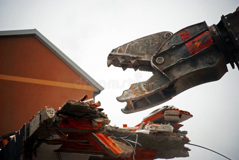 Closeup of the jaws of demolition machinery in the process of tearing down a portion of a building. Claw machine stock images, royalty-free photos and pictures