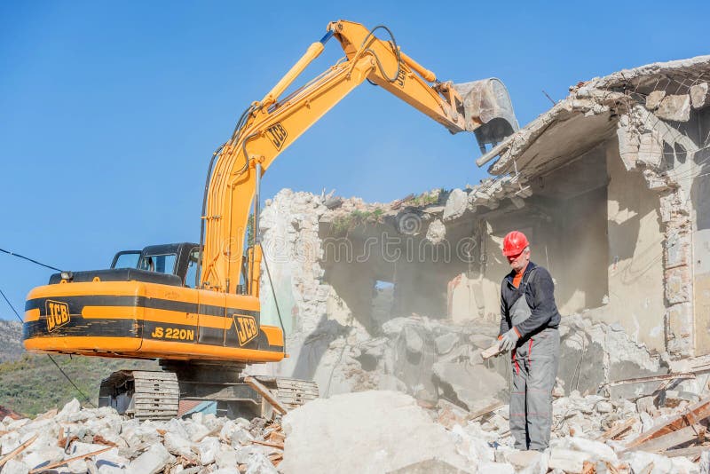 Tivat, Montenegro- December 7, 2016: Demolition of an old house with excavator