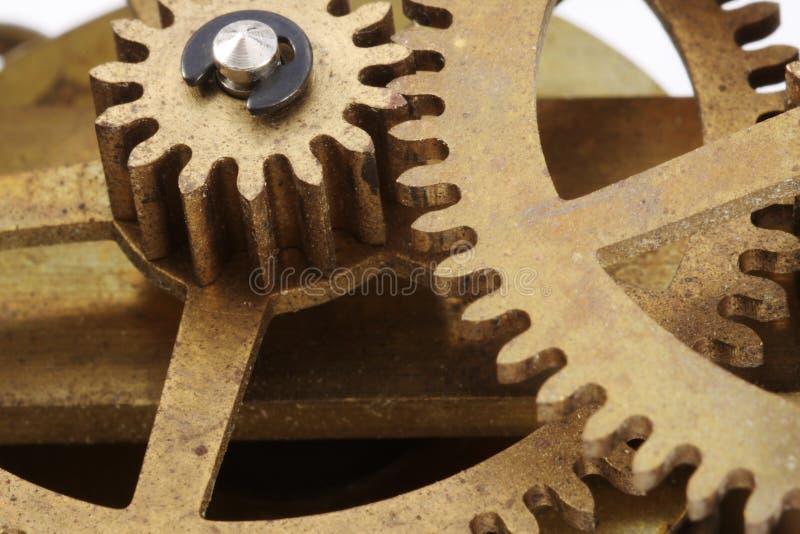 Gears from an antique clock in a close-up view. Gears from an antique clock in a close-up view.