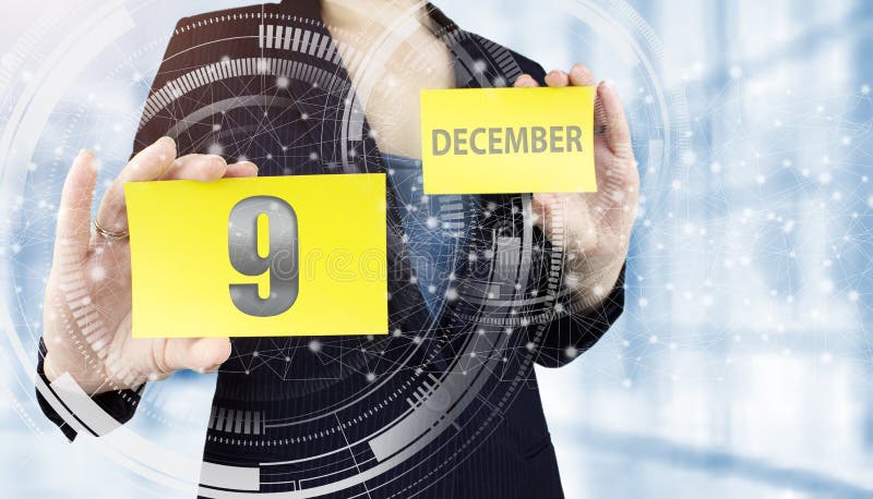 December 9th. Day 9 of month, Calendar date. Business woman hand hold yellow sheet with calendar date on blurred office background. Winter month, day of the year concept. December 9th. Day 9 of month, Calendar date. Business woman hand hold yellow sheet with calendar date on blurred office background. Winter month, day of the year concept